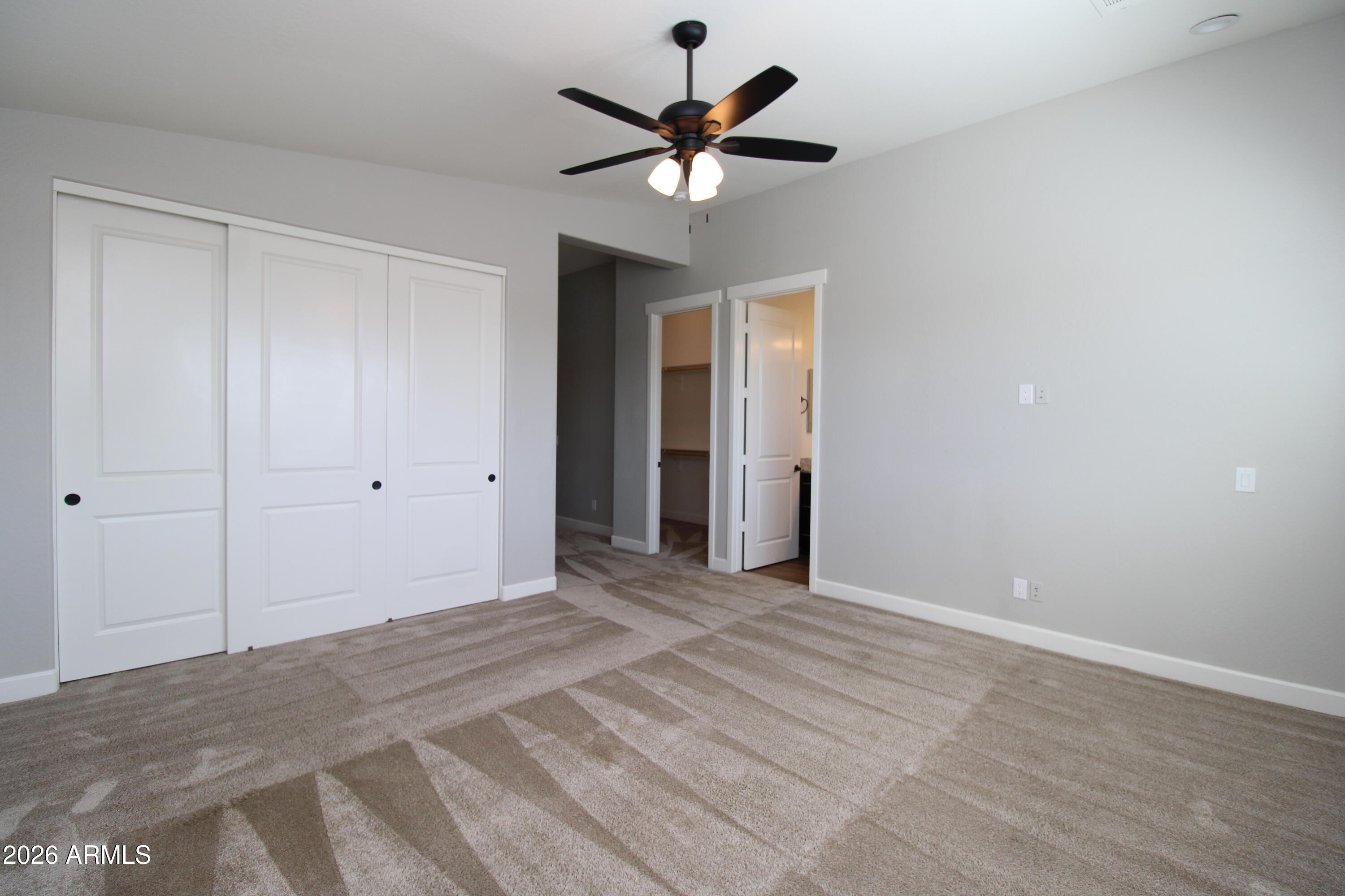 1024 East Curry Road, Unit 1A Tempe, AZ 85288 - Photo 7 of 23 a view of an empty room with a ceiling fan