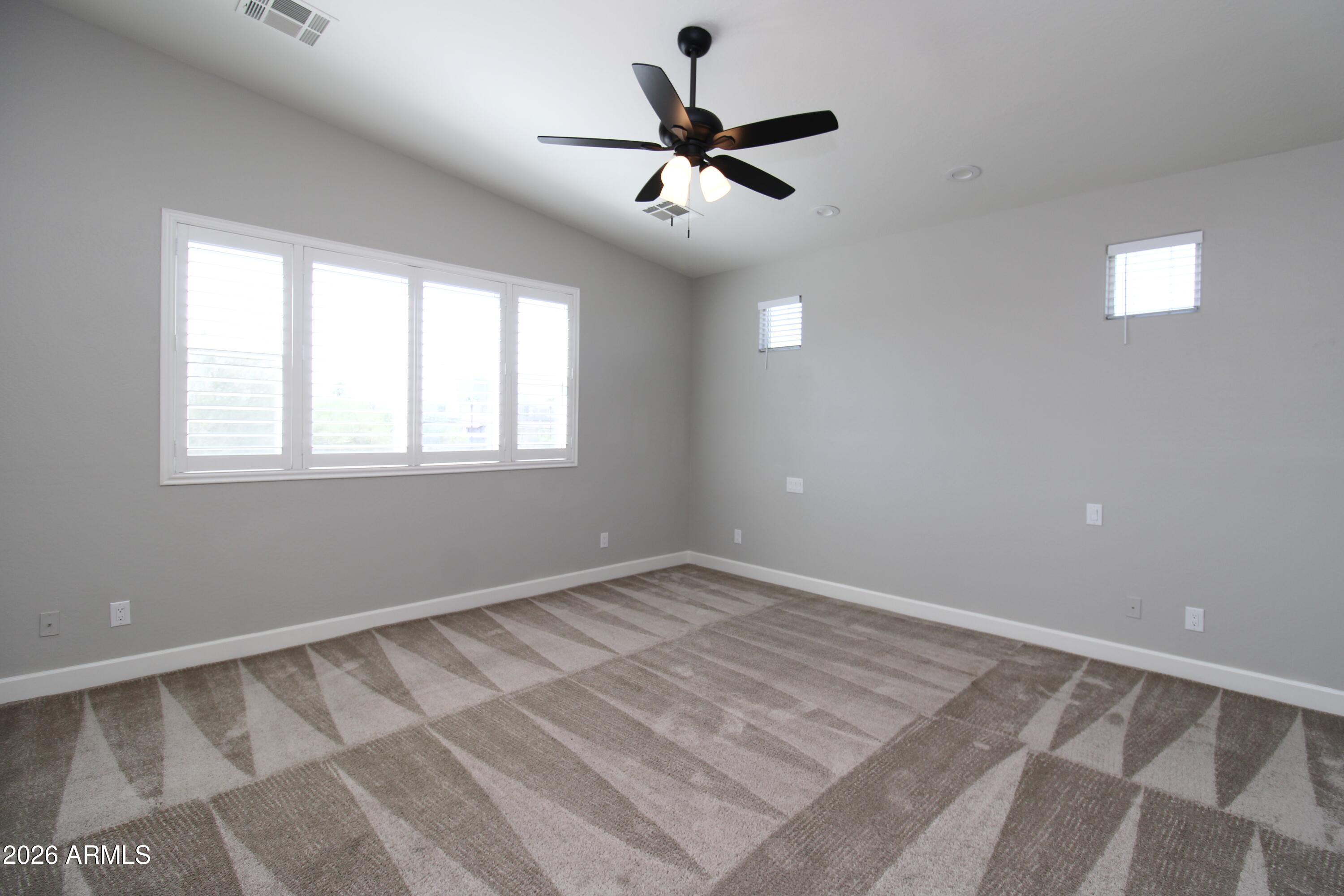 1024 East Curry Road, Unit 1A Tempe, AZ 85288 - Photo 8 of 23 a view of room with a ceiling fan