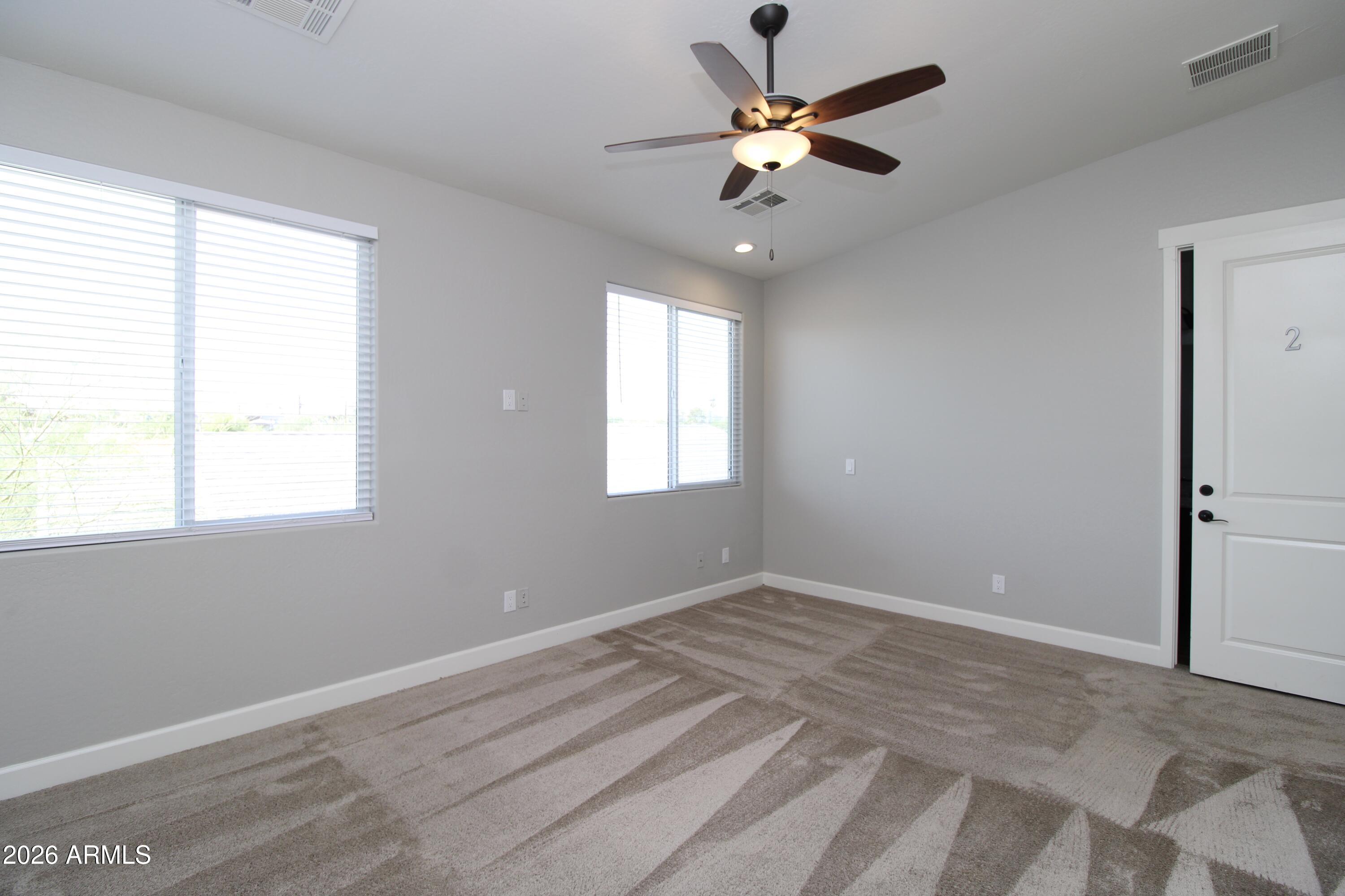 1024 East Curry Road, Unit 1A Tempe, AZ 85288 - Photo 10 of 23 wooden floor in an empty room with a window