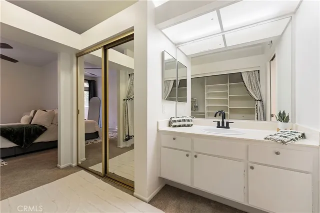 a en suite bathroom with a toilet sink and mirror