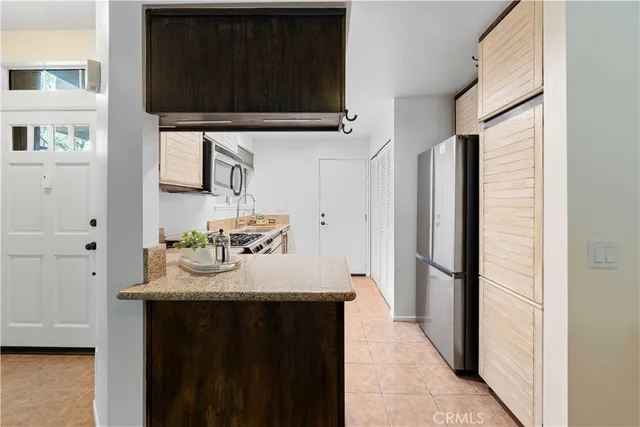 a kitchen with a sink stove and refrigerator