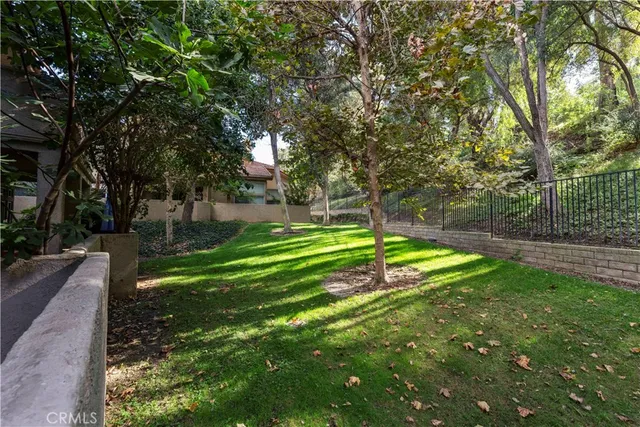 a view of a house with a yard and a large park