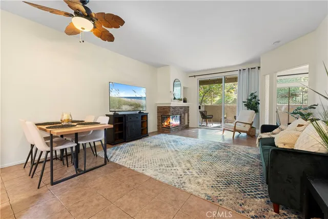 a living room with fireplace furniture and a window