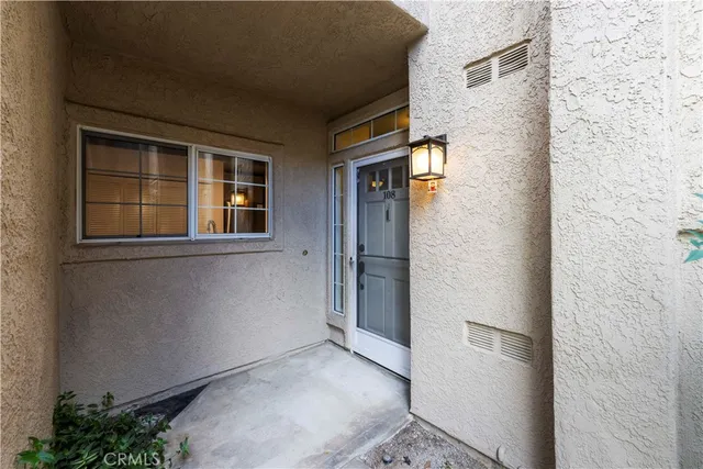 an aerial view of a house with swimming pool and large trees