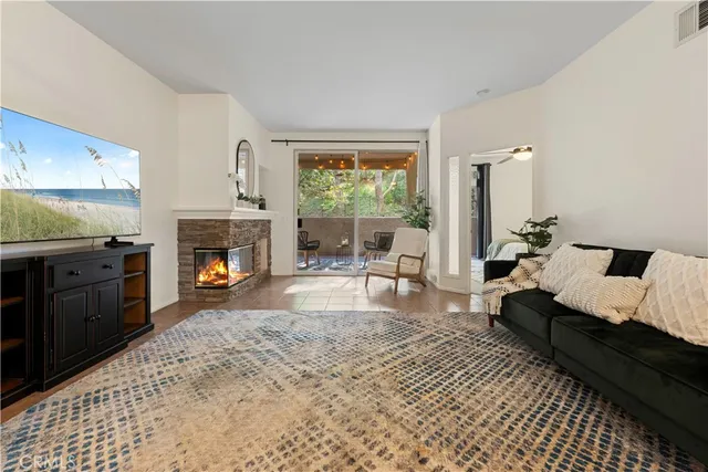 a living room with furniture a window and a fireplace