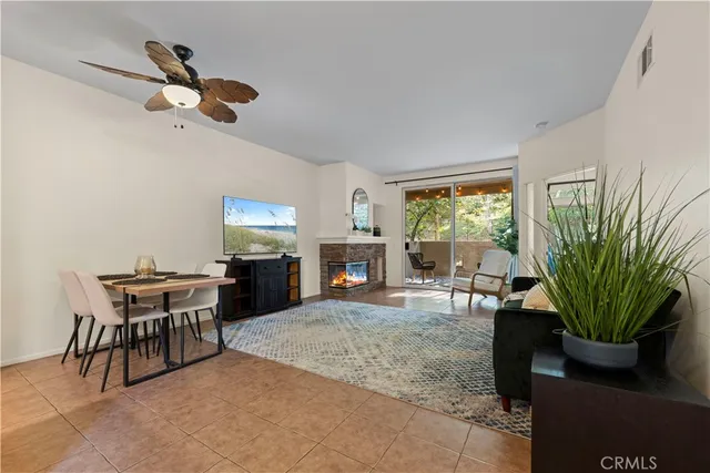 a living room with furniture a window and a fireplace