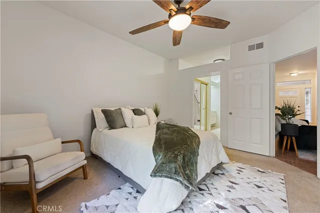 a spacious bedroom with a bed and a couch