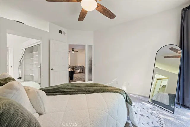 a bedroom with a bed and a mirror