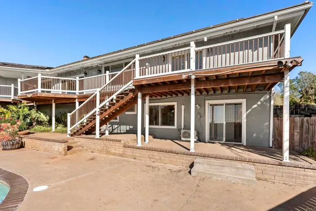 a view of a house with backyard porch and sitting area