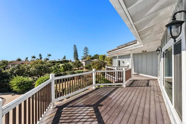 a view of a balcony with wooden floor