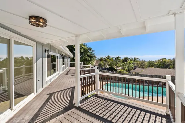a view of a balcony with wooden floor
