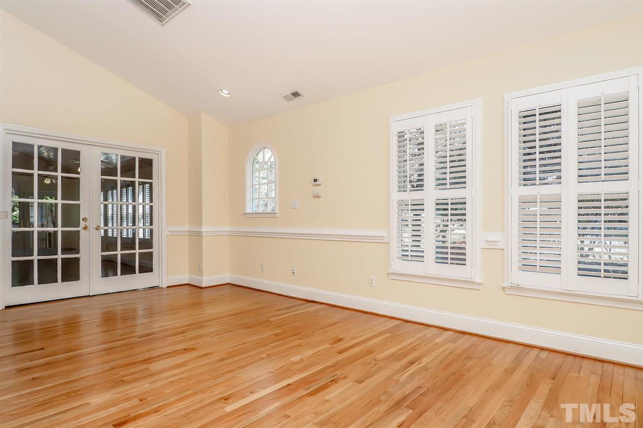5800 Contour Drive Raleigh, NC 27612 - Photo 11 of 19 a view of an empty room with wooden floor and a window