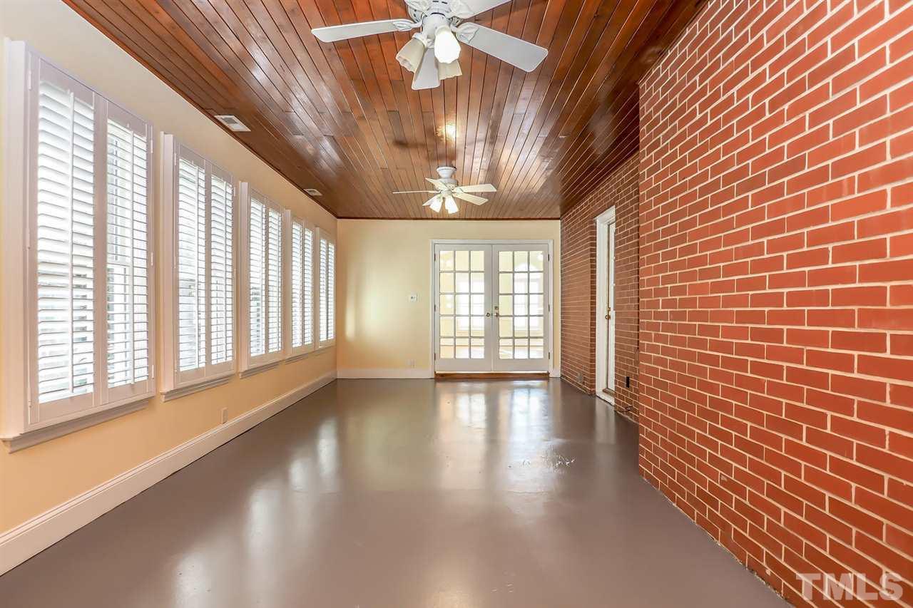 5800 Contour Drive Raleigh, NC 27612 - Photo 13 of 19 a view of an empty room with wooden floor and a window