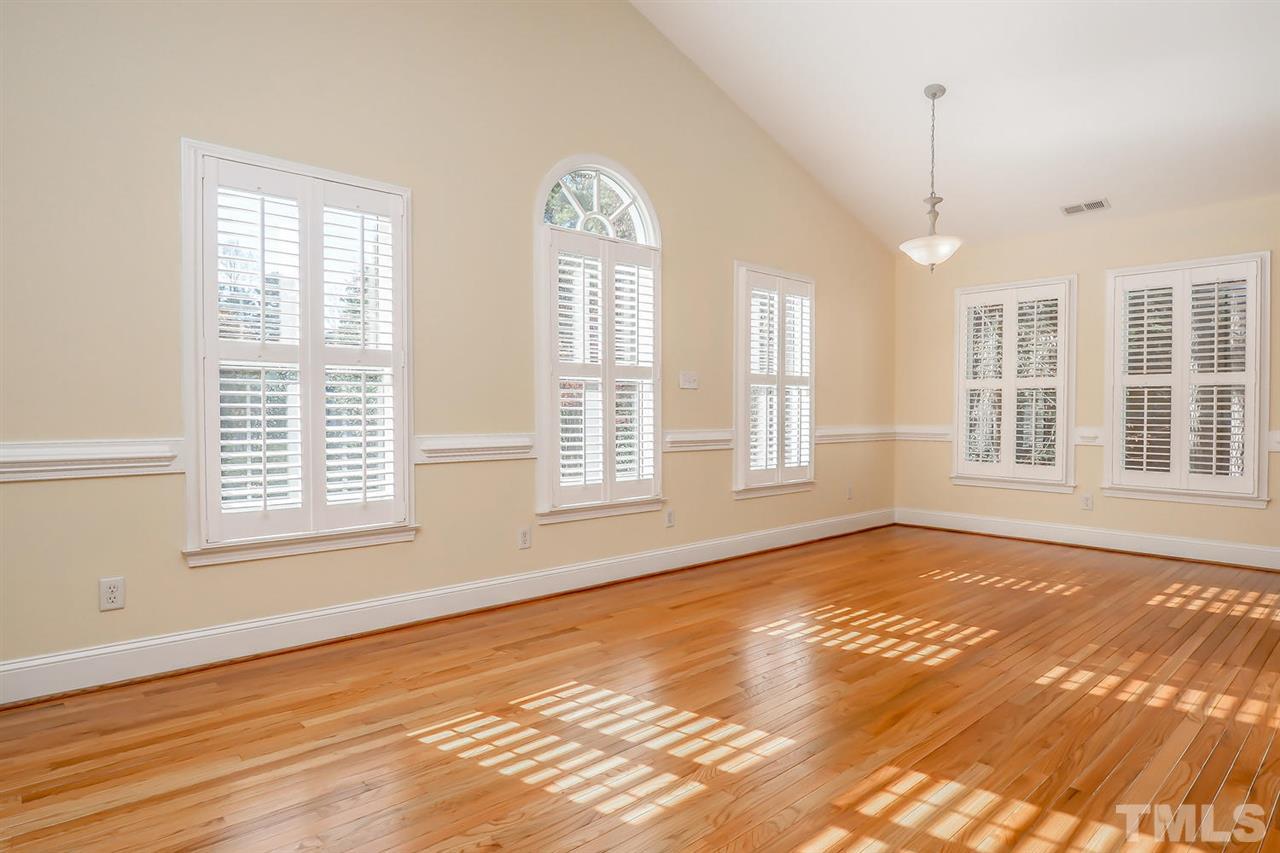 5800 Contour Drive Raleigh, NC 27612 - Photo 8 of 19 a view of an empty room with wooden floor and a window