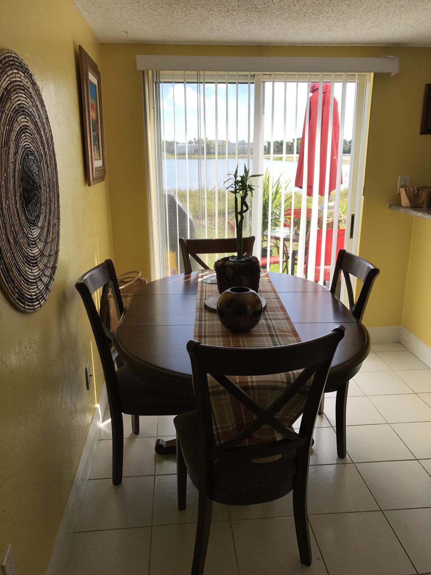 164 Riviera Circle Weston, FL 33326 - Photo 6 of 26 a view of a dining room with furniture and a large window