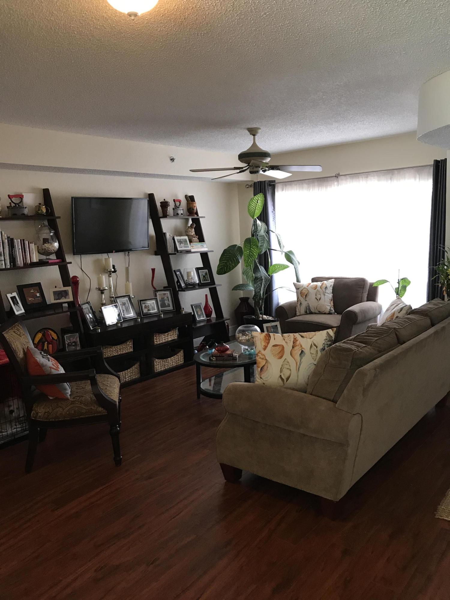164 Riviera Circle Weston, FL 33326 - Photo 7 of 26 a living room with furniture and a chandelier