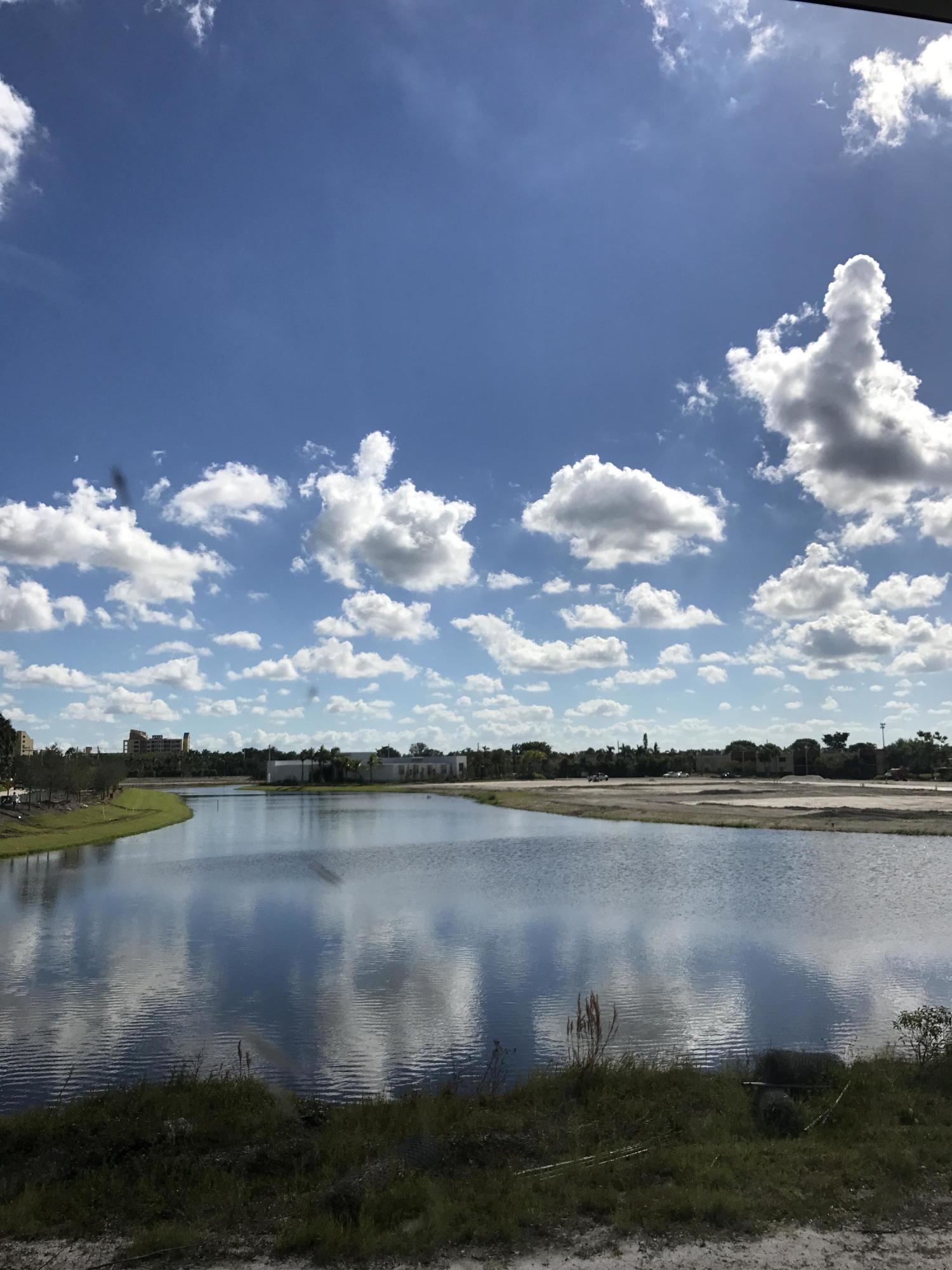 164 Riviera Circle Weston, FL 33326 - Photo 8 of 26 a view of a lake with a city