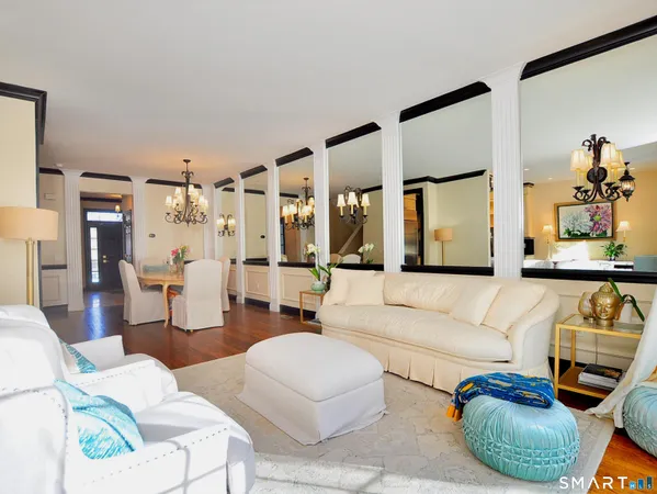 a living room with furniture and a large mirror