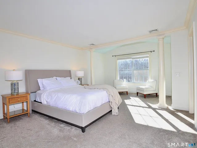 a bedroom with a bed and a couch