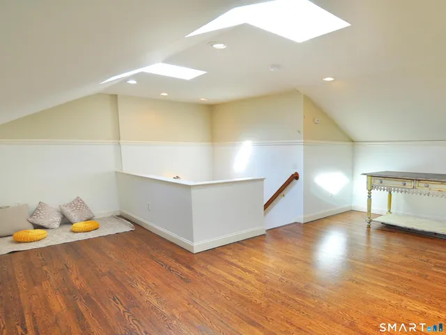 a view of entryway with wooden floor and stairs