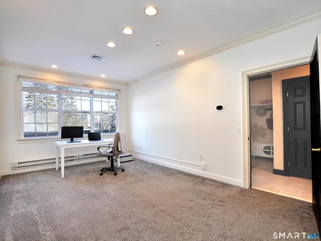 a view of a walk in closet and bathroom