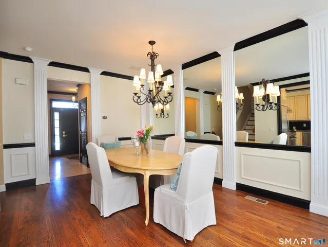 a living room with furniture and a large mirror