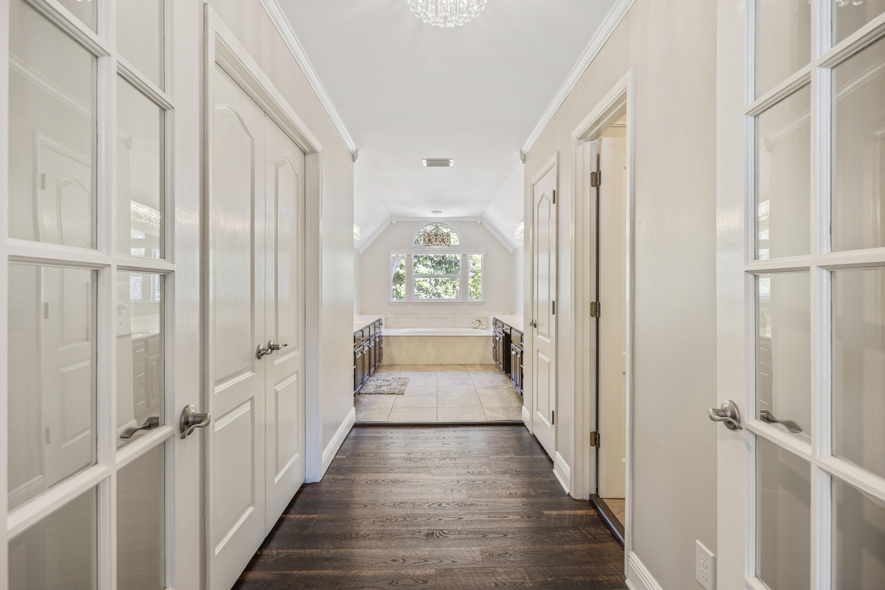 147 Eldredge Road Fort Walton Beach, FL 32547 - Photo 27 of 82 a view of a hallway with wooden floor and windows
