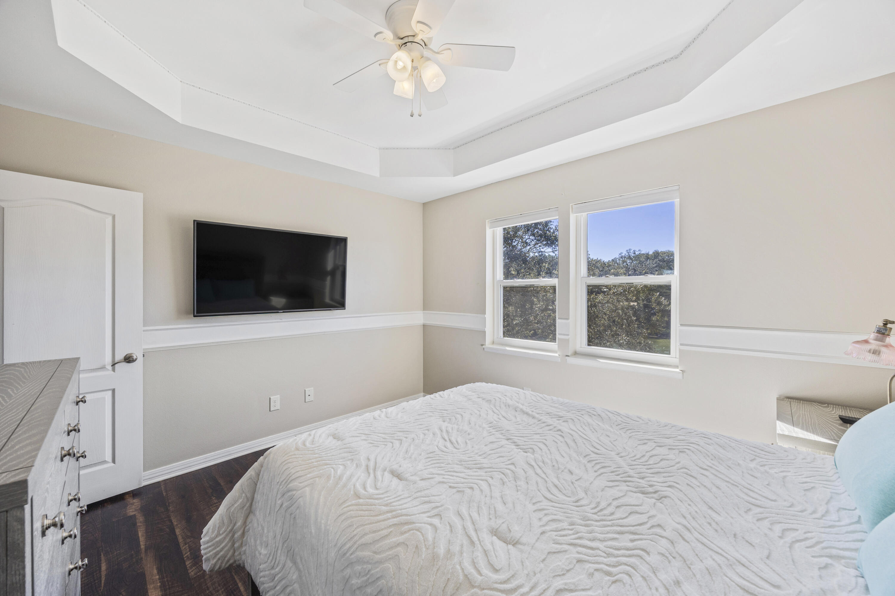 147 Eldredge Road Fort Walton Beach, FL 32547 - Photo 38 of 82 a bedroom with a large bed and a flat tv screen on dresser