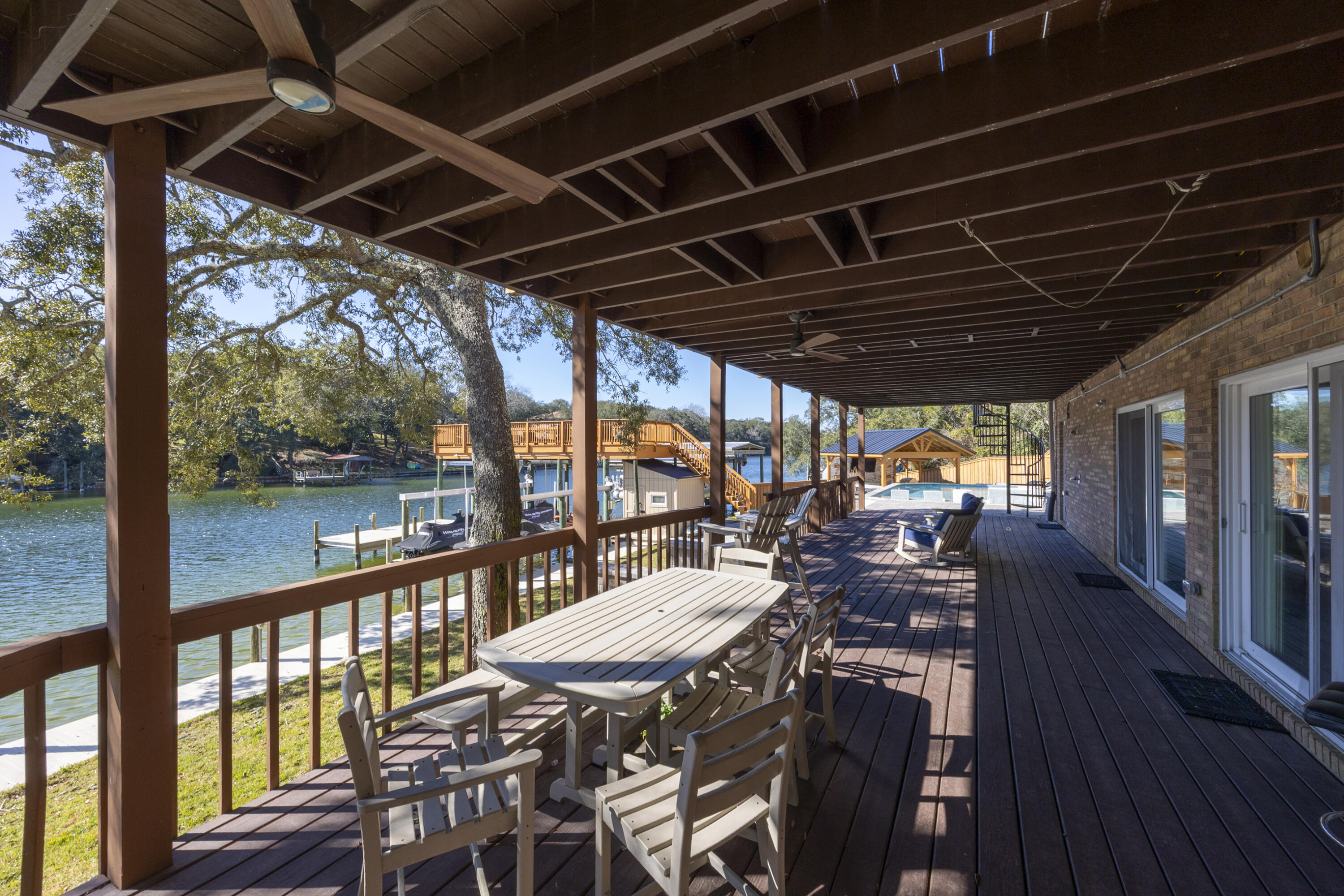 147 Eldredge Road Fort Walton Beach, FL 32547 - Photo 59 of 82 a view of a patio with wooden floor a yard tables and chairs