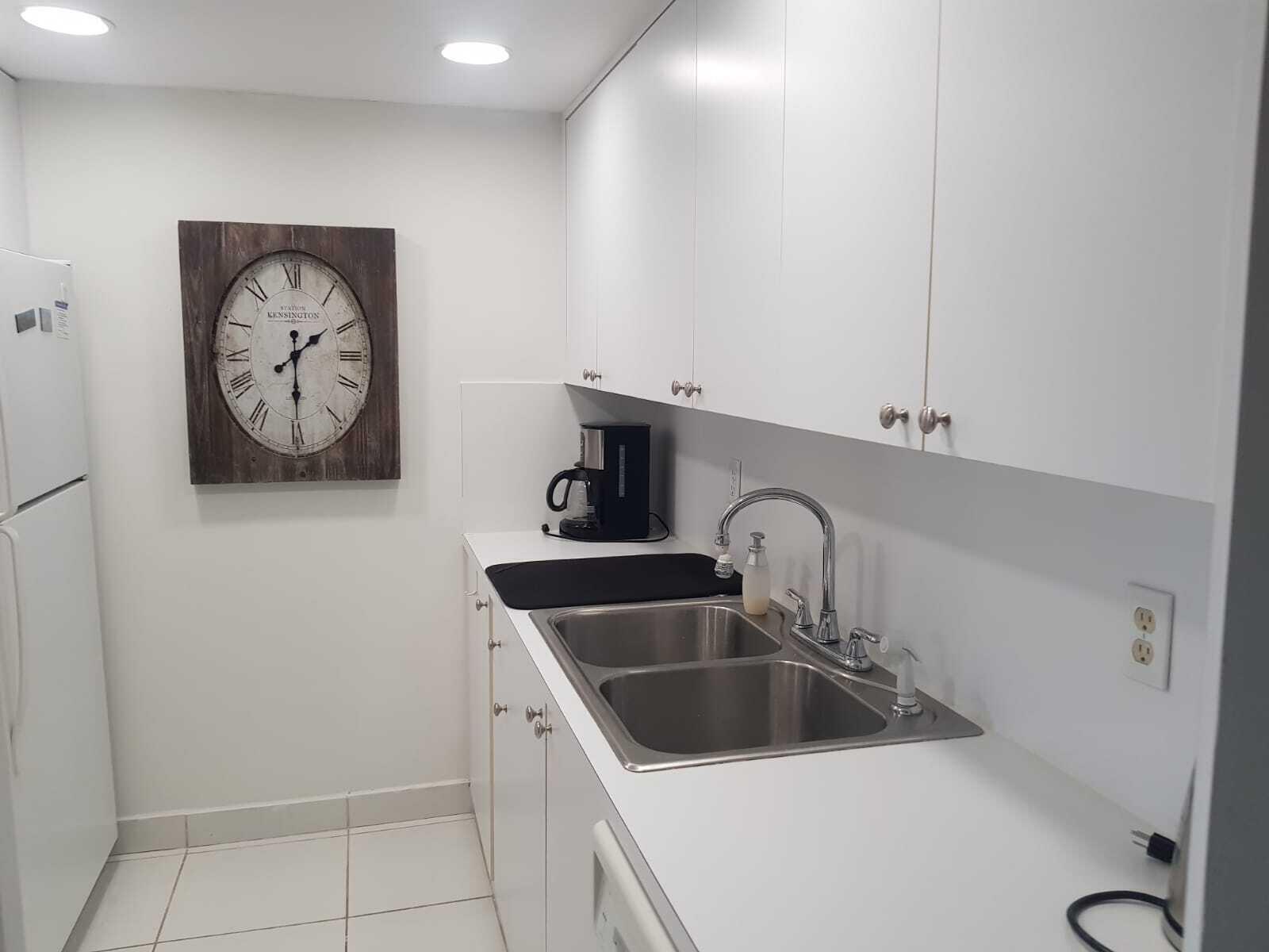 4014 Cornwall East, Unit 4014 Boca Raton, FL 33434 - Photo 12 of 67 a kitchen with a sink and a stove with wooden floor