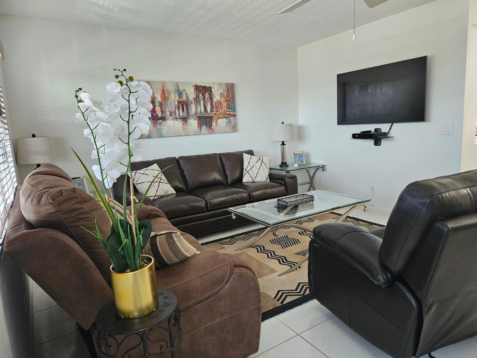 4014 Cornwall East, Unit 4014 Boca Raton, FL 33434 - Photo 2 of 67 a living room with furniture and a flat screen tv