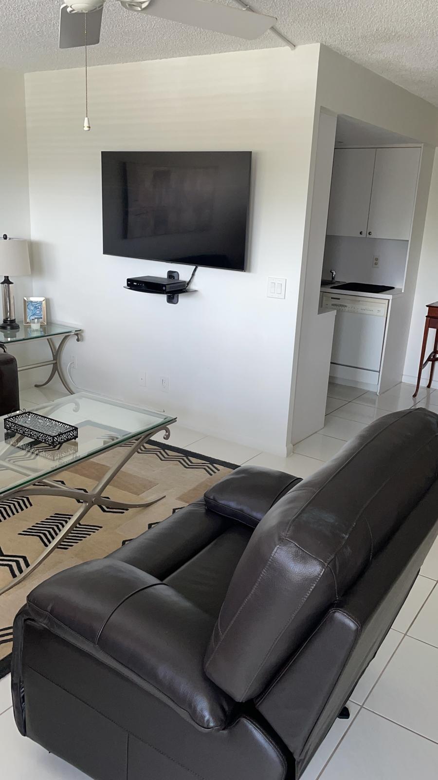 4014 Cornwall East, Unit 4014 Boca Raton, FL 33434 - Photo 4 of 67 a living room with furniture and a flat screen tv