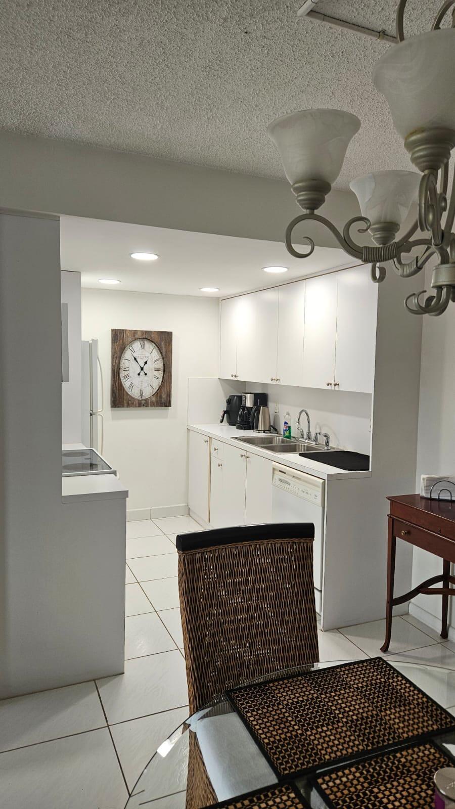 4014 Cornwall East, Unit 4014 Boca Raton, FL 33434 - Photo 10 of 67 a kitchen with stainless steel appliances kitchen island granite countertop a stove a sink and a refrigerator