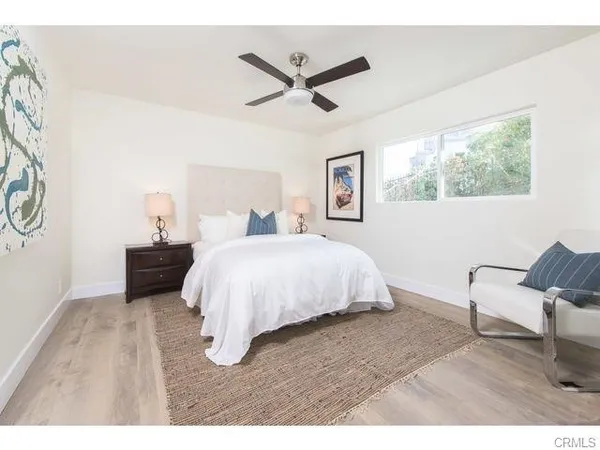 a bed room with a bed and a chair