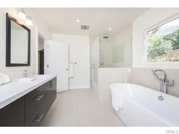 a bathroom with a double vanity sink mirror and double