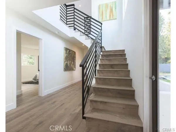 a view of entryway and hall with wooden floor