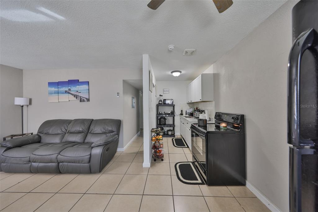 11708 Balm Riverview Road Riverview, FL 33569 - Photo 26 of 37 a living room with furniture a flat screen tv and gym equipment