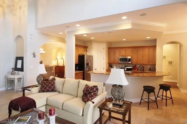 a living room with furniture and kitchen view