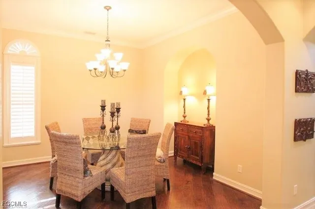 a dining room with furniture and wooden floor
