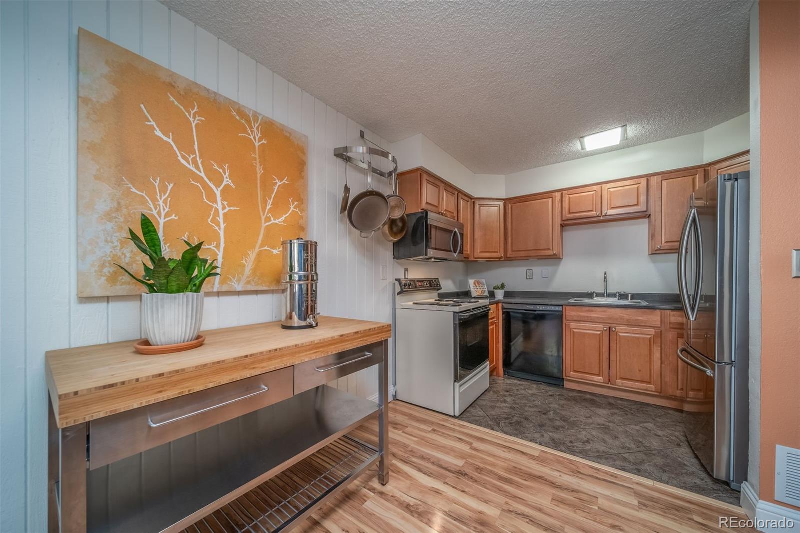 3375 Chisholm Trail, Unit A102 Boulder, CO 80301 - Photo 11 of 40 a kitchen with stainless steel appliances granite countertop a sink a stove and a wooden floors