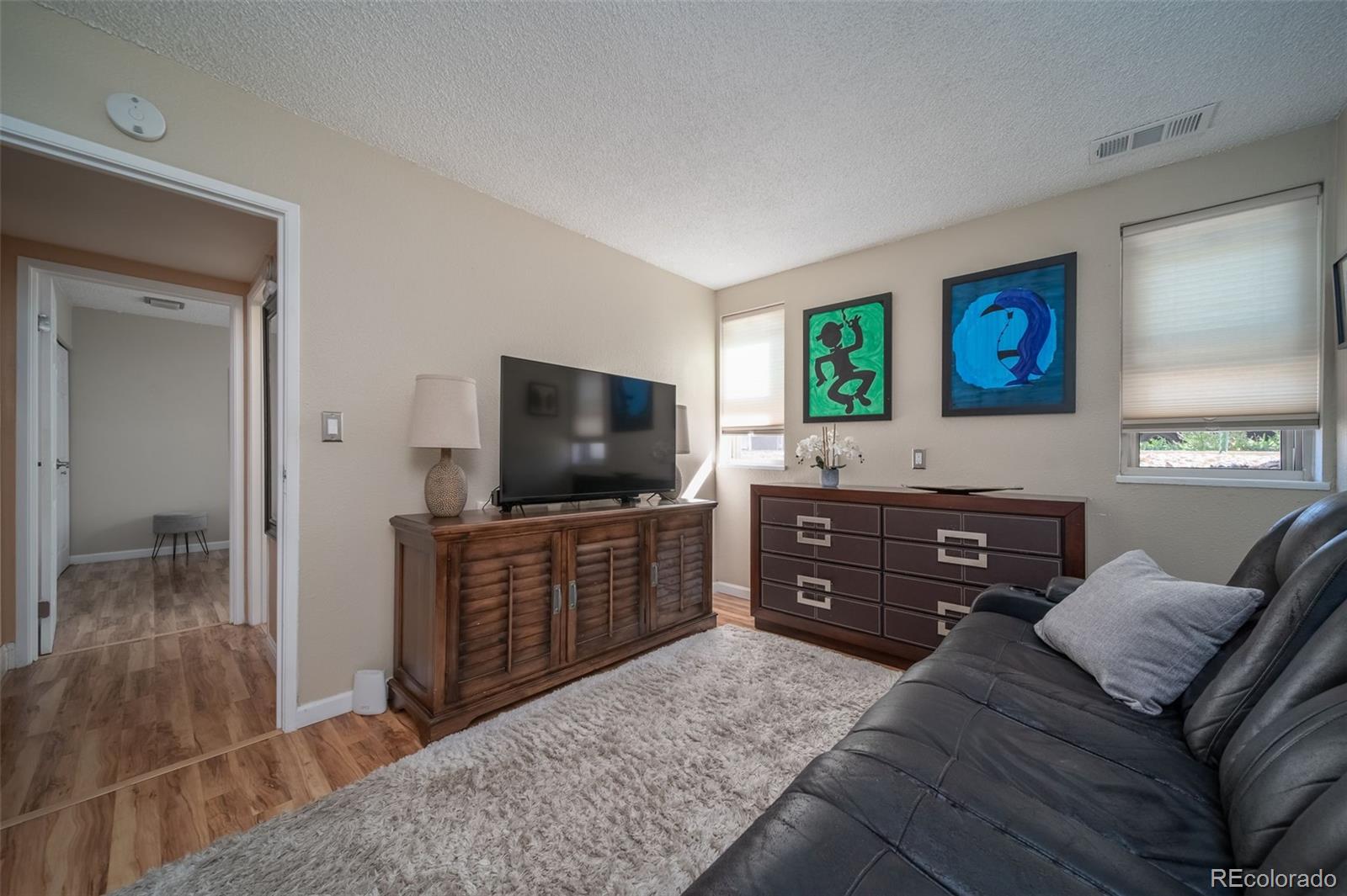 3375 Chisholm Trail, Unit A102 Boulder, CO 80301 - Photo 15 of 40 a bedroom with a bed and flat screen tv