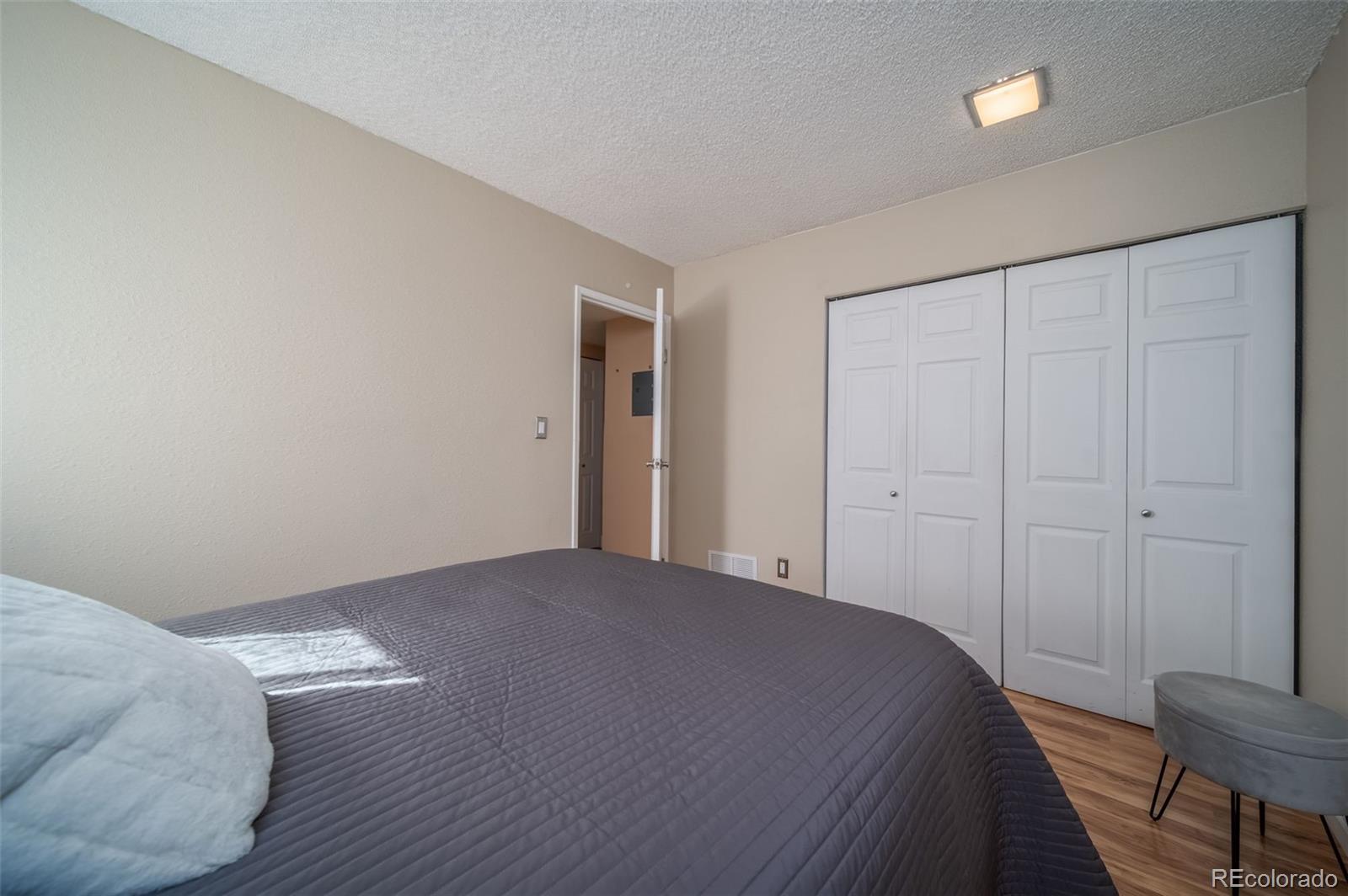 3375 Chisholm Trail, Unit A102 Boulder, CO 80301 - Photo 17 of 40 a bedroom with a bed and a table