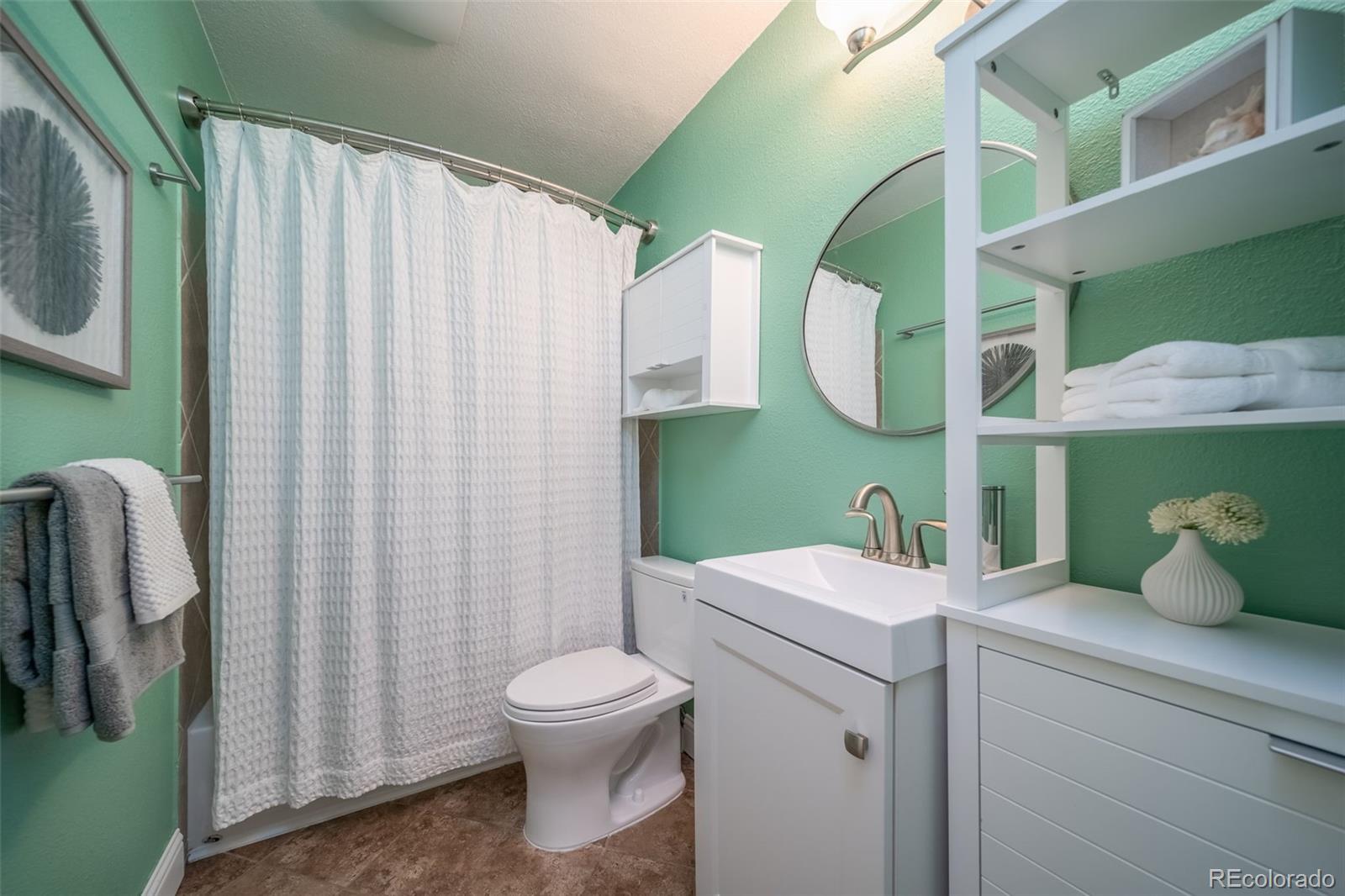 3375 Chisholm Trail, Unit A102 Boulder, CO 80301 - Photo 18 of 40 a bathroom with a sink a toilet and a mirror