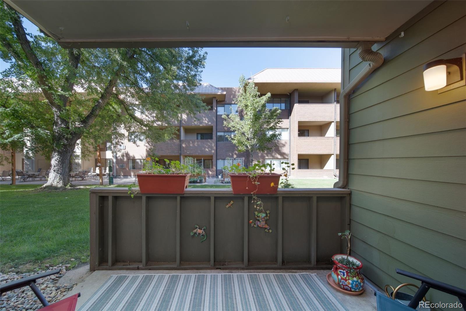 3375 Chisholm Trail, Unit A102 Boulder, CO 80301 - Photo 19 of 40 a view of a house with backyard and sitting area