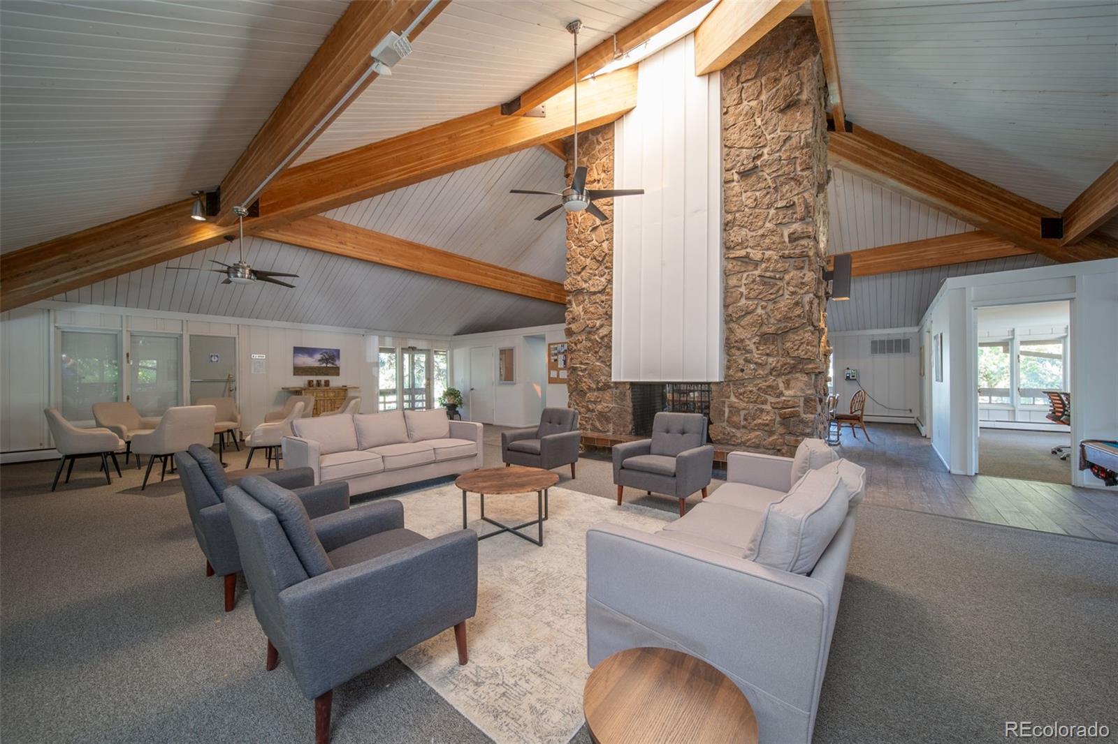3375 Chisholm Trail, Unit A102 Boulder, CO 80301 - Photo 28 of 40 a living room with fireplace furniture and a ceiling fan