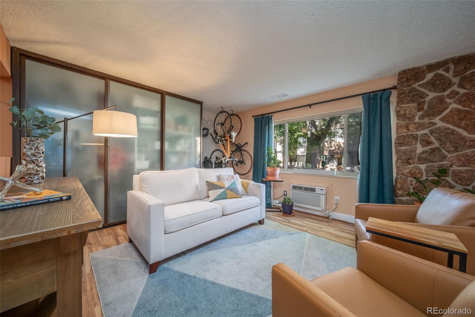 3375 Chisholm Trail, Unit A102 Boulder, CO 80301 - Photo 4 of 40 a living room with furniture and a large window