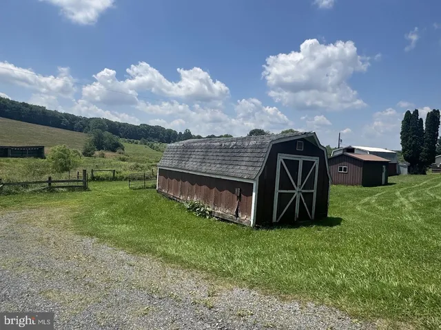a view of a garden with a wooden fence