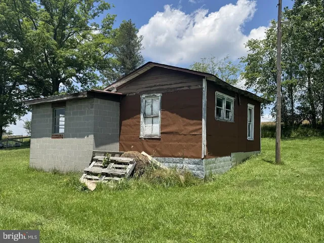 a front view of house with yard and trees