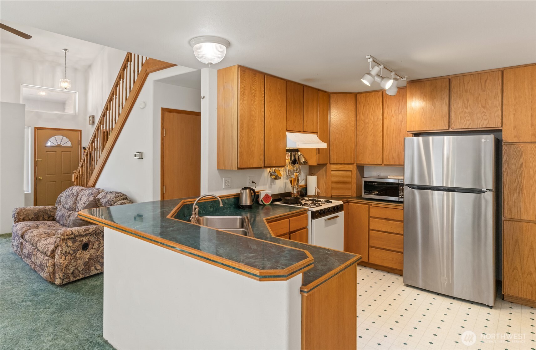 17976 Entiat River Road Entiat, WA 98822 - Photo 24 of 40 a kitchen with a sink refrigerator and cabinets