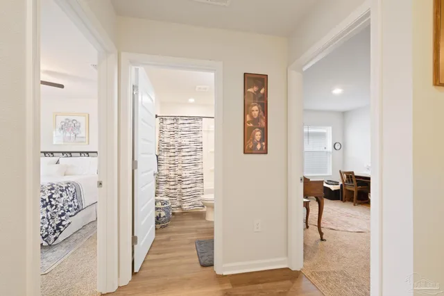 a bathroom with a granite countertop toilet sink and mirror